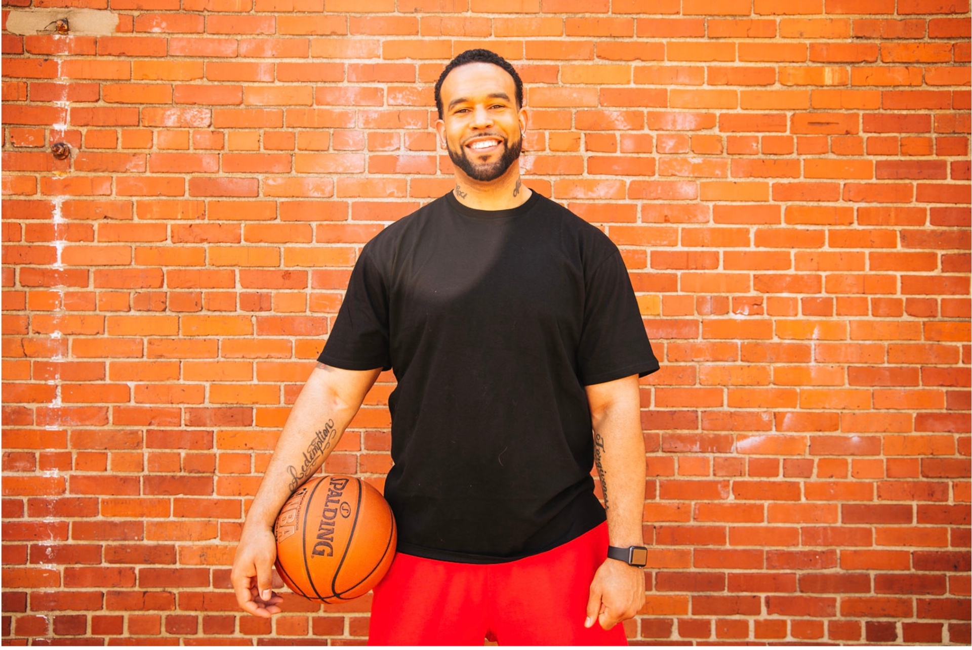 Portrait of Coach CJ Appleton holding a basketball
